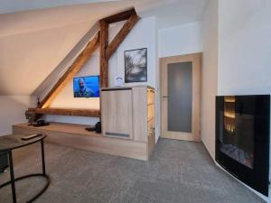 a room with a bed and a tv in a room at Apartmán Na Břehu in Luhačovice +16 photos