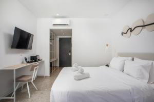 A bed or beds in a room at Aiora Resort