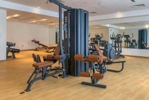 a gym with a bunch of exercise equipment in it at 1BR + maid room Apartment in Downtown Dubai in Dubai