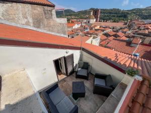 an overhead view of a balcony with chairs on a building at Sardinian Gallery Domus Historic Rooms & Apartments in Bosa