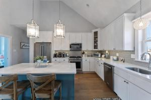 a kitchen with white cabinets and a blue island at 201 W 24Th Ave in Wildwood