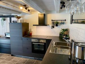 a kitchen with a sink and a counter top at Charming 5 bed studio at Getterön in Varberg +19 photos