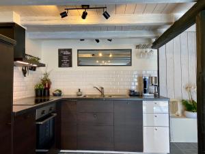 a kitchen with a sink and a counter top at Charming 5 bed studio at Getterön in Varberg