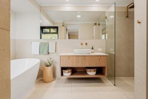 a bathroom with a sink and a tub and a mirror at Wildwood Retreat a Luxury Vineyard Escape in Yallingup Siding +20 photos