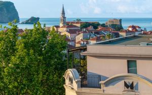 a view of a city and the ocean from a building at Hotel Majestic in Budva