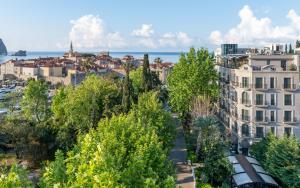 a view of a city with trees and buildings at Hotel Majestic in Budva
