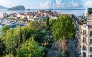 an aerial view of a city with a harbor at Hotel Majestic in Budva