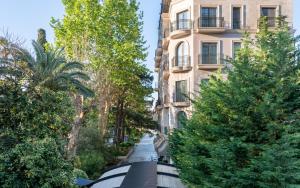 a street with trees in front of a building at Hotel Majestic in Budva
