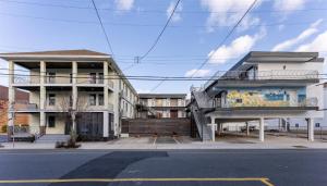 a building with a staircase on the side of a street at 313 E Glenwood Ave, Unit 109 in Wildwood