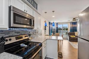 a kitchen with a stove and a microwave at 307 E Crocus Rd, Unit B in Wildwood Crest