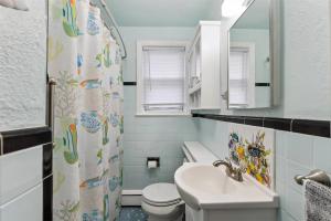 a bathroom with a sink and a toilet and a mirror at 307 E Crocus Rd, Unit B in Wildwood Crest +21 photos