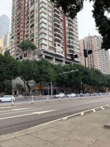 a city street with cars parked in front of tall buildings at Youmi Hotel-Chongqing Hongyadong Chaotianmen in Chongqing +26 photos