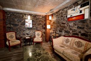 a living room with a couch and two chairs at Shale Tsagveri in Tsaghveri