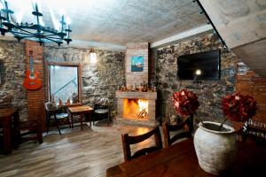 a living room with a fireplace and a tv at Shale Tsagveri in Tsaghveri