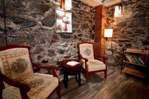 a living room with two chairs and a table at Shale Tsagveri in Tsaghveri