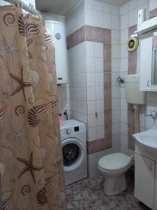 a bathroom with a toilet and a washing machine at Exit NS in Novi Sad