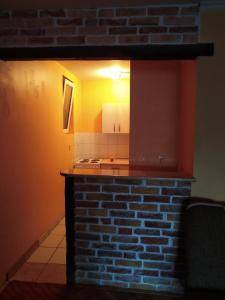 a kitchen with a brick counter with a light on it at Exit NS in Novi Sad