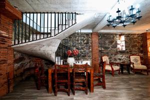 a dining room with a table and a staircase at Shale Tsagveri in Tsaghveri +52 photos