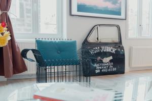 a glass table with a chair and a bag at Les Séquoias #MaisonSavaron in Clermont-Ferrand +51 photos