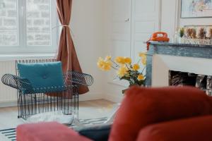 a living room with a chair and a fireplace at Les Séquoias #MaisonSavaron in Clermont-Ferrand