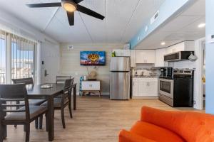 a kitchen and dining room with a table and a ceiling fan at 301 Ocean Ave, Unit 316 - The Harbor Light in North Wildwood