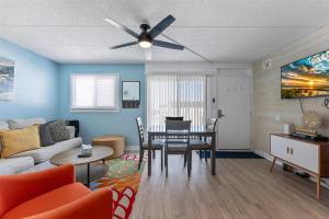 a living room with a couch and a table at 301 Ocean Ave, Unit 316 - The Harbor Light in North Wildwood