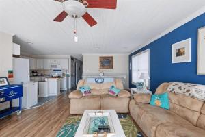 a living room with a couch and a ceiling fan at Gorgeous 3 Bedroom Condo with Ocean Views & Garage Parking in Wildwood +11 photos