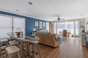 a living room with a couch and a table at Gorgeous 3 Bedroom Condo with Ocean Views & Garage Parking in Wildwood