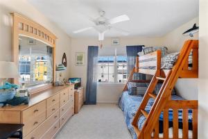 a bedroom with a bunk bed and a desk at Gorgeous 3 Bedroom Condo with Ocean Views & Garage Parking in Wildwood