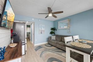 a living room with a couch and a ceiling fan at 301 Ocean Ave, Unit 110 - The Harbor Light in North Wildwood