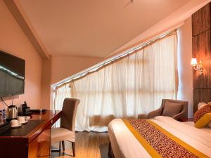 a hotel room with a bed and a desk and a window at Resort World Terelj Hotel in Bayan Bulagiin Hural