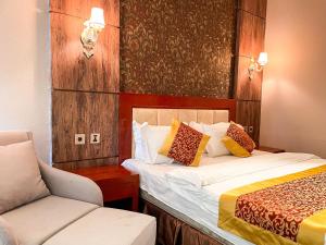 a hotel room with two beds and a chair at Resort World Terelj Hotel in Bayan Bulagiin Hural