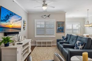 a living room with a blue couch and a tv at Residence 304S At The Sandcastle Condominiums in Wildwood Crest
