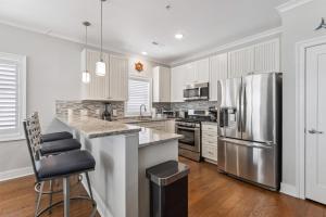 a kitchen with white cabinets and a stainless steel refrigerator at Residence 304S At The Sandcastle Condominiums in Wildwood Crest