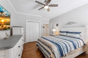 a white bedroom with a bed and a ceiling fan at Residence 304S At The Sandcastle Condominiums in Wildwood Crest +26 photos