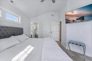 a large white bedroom with a large white bed at 225 E Youngs Ave, Unit A in Wildwood