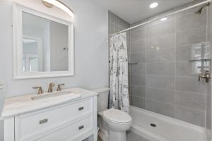 a bathroom with a sink and a toilet and a shower at 225 E Youngs Ave, Unit A in Wildwood +27 photos