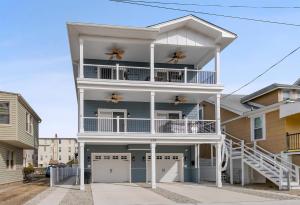 a white house with a balcony on a street at 225 E Youngs Ave, Unit A in Wildwood