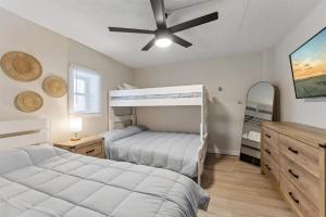 a bedroom with two beds and a ceiling fan at 301 Ocean Ave, Unit 204 - The Harbor Light in North Wildwood +14 photos