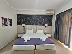 Postel nebo postele na pokoji v ubytování Hotel Pini