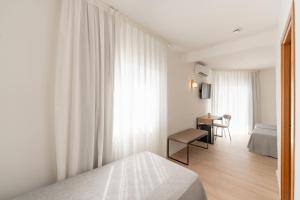 Postel nebo postele na pokoji v ubytování Hotel RH Sol