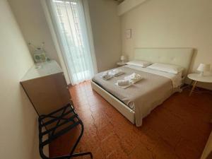 a bedroom with a bed with two towels on it at Casa Casò Guest House in Bologna +13 photos