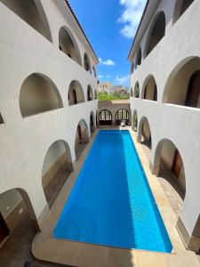 an indoor pool in a building with arches at Villa al Andalous in Sidi Krir 