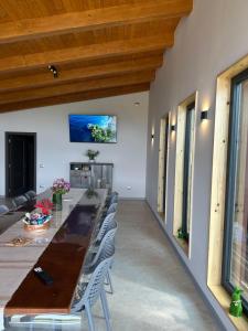 a dining room with a long table and chairs at A Green Nest in Suceava
