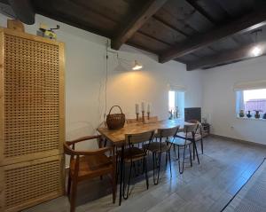 a dining room with a wooden table and chairs at Drevenica U Feleja in Pohorelá