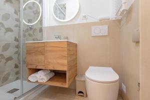 a small bathroom with a toilet and a shower at Hotel Victoria in Finale Ligure +43 photos