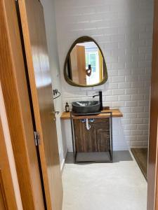 a bathroom with a sink and a mirror at Casa Bambu, Paraiso na Terra in Praia Verde +38 photos
