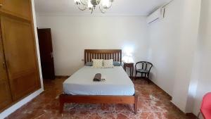 a bedroom with a bed and a chandelier at Murcia a tus pies, La Alberca in La Alberca