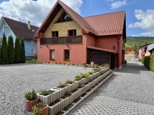 a house with a fence in front of a driveway at Vitaneo in Vitanová
