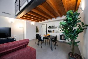 a living room with a red couch and a table at Maison Selva - Palazzo Cervi Duplex Superior in Salò